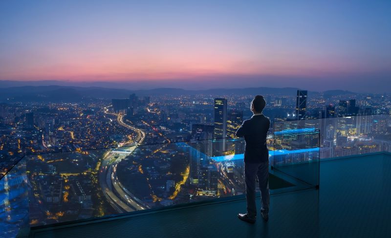 Man overlooking a modern city.